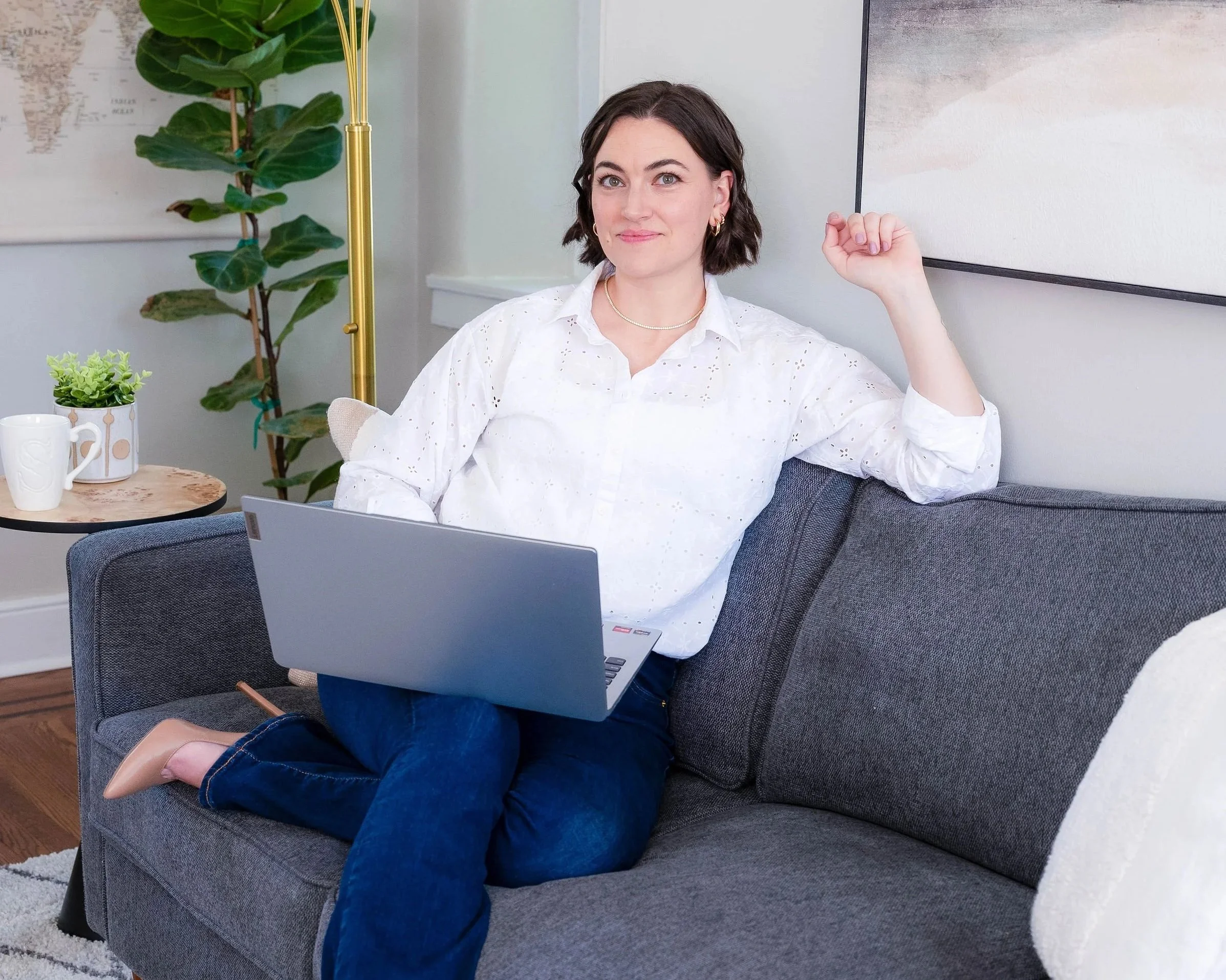 Shelley Snapp, LMFT-AS, working on her laptop from a bright, plant-filled therapy office