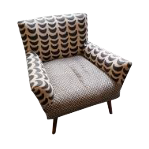 A vintage armchair with patterned upholstery in shades of brown, black, and white, featuring rounded arms and wooden legs.