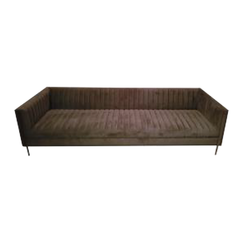 A long, brown velvet sofa with a ribbed pattern, set against a black background.