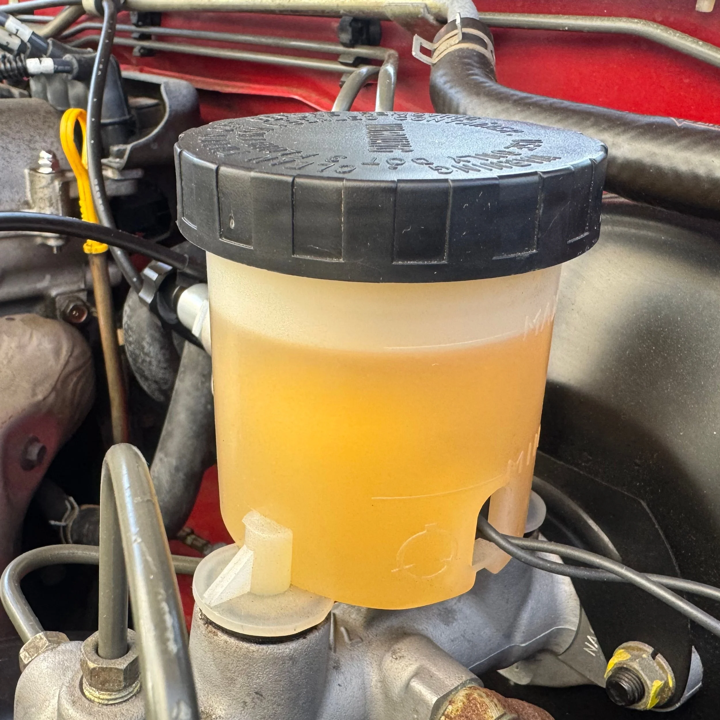 Brake master cylinder reservoir from a 1990 NA Miata MX-5. Link leads to NA Fluids section of website.