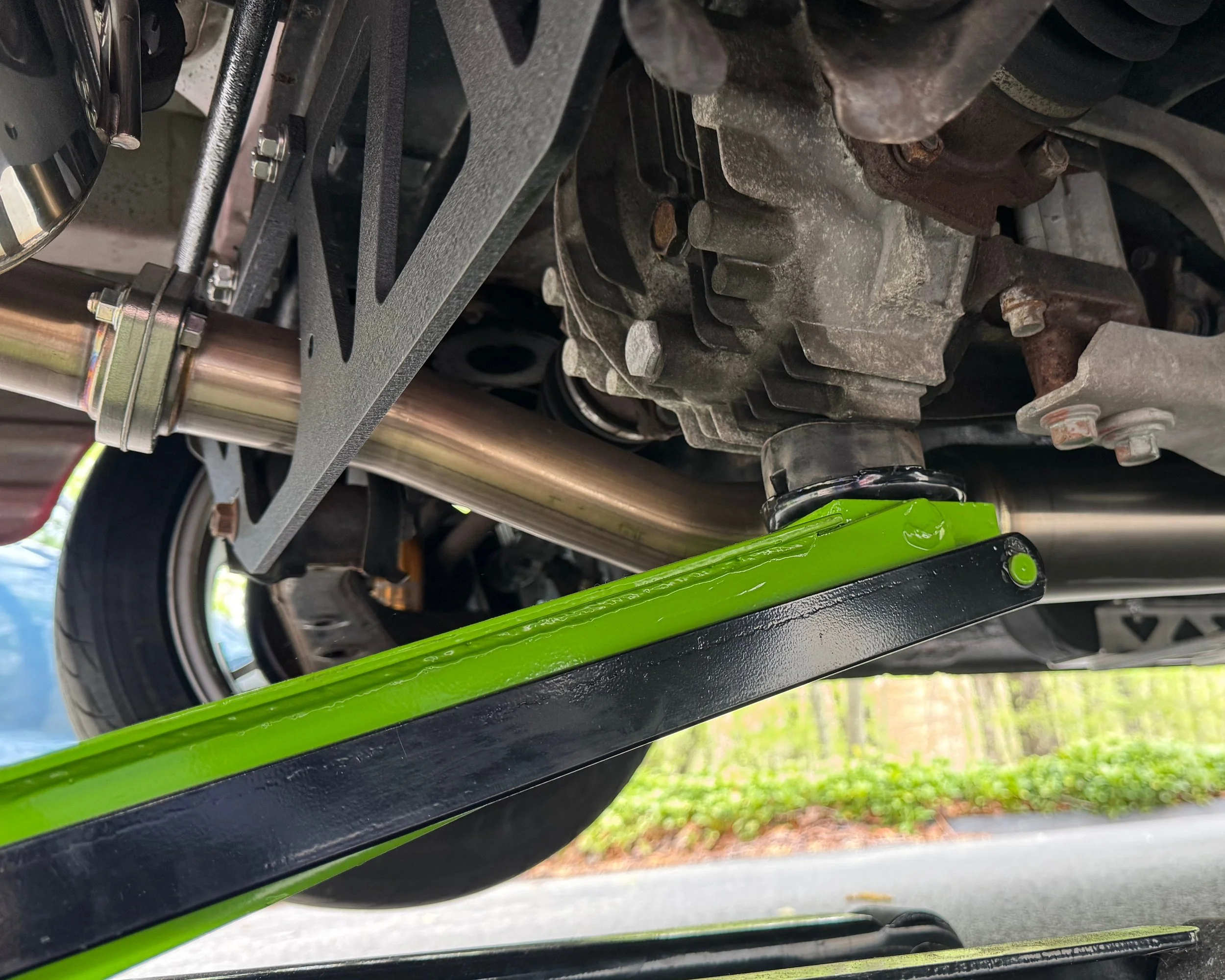 NA Mazda Miata MX-5 hydraulic lift under the rear differential to show the proper location to lift the rear of the car