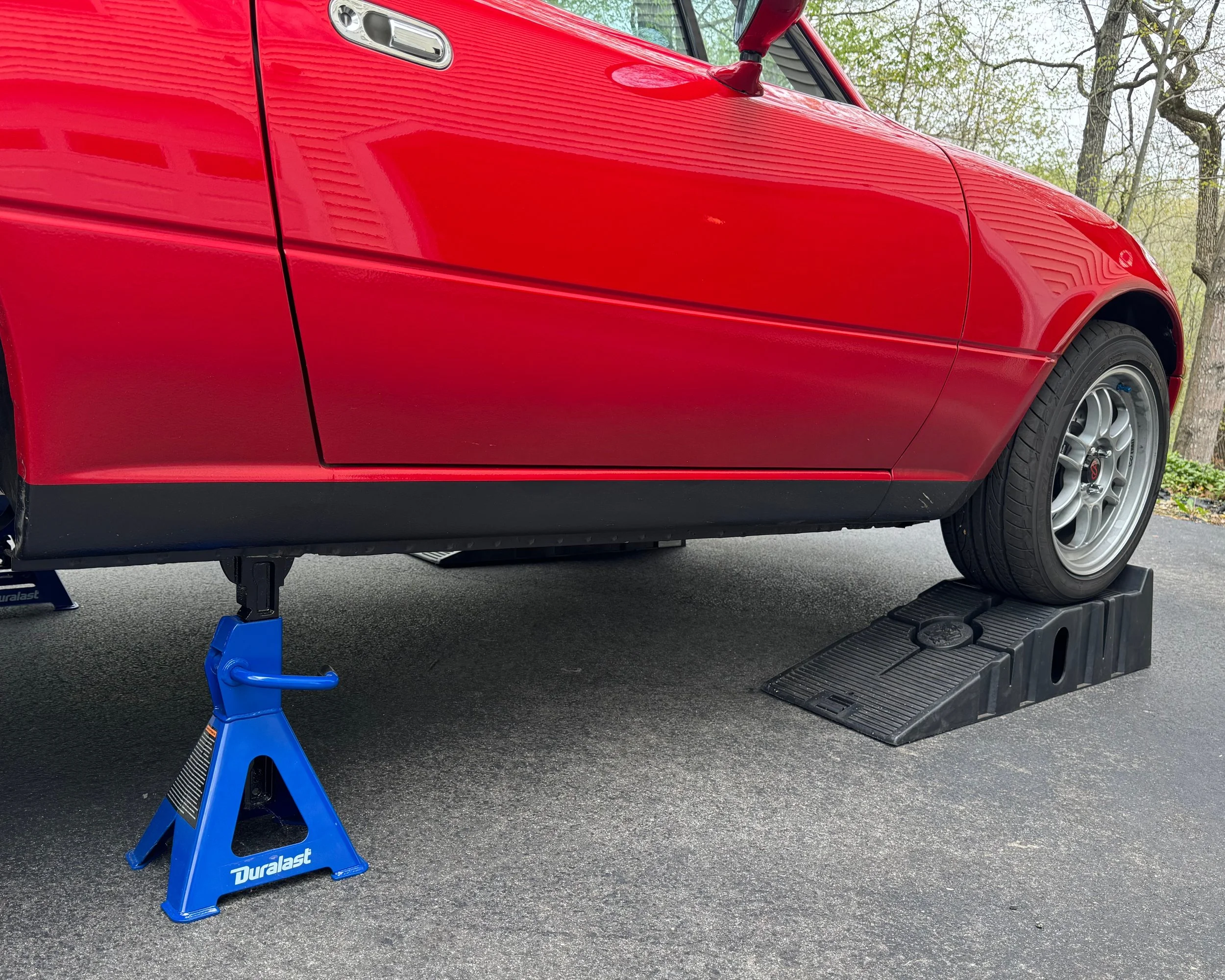 NA Mazda Miata MX-5 classic red on ramps and jack stands