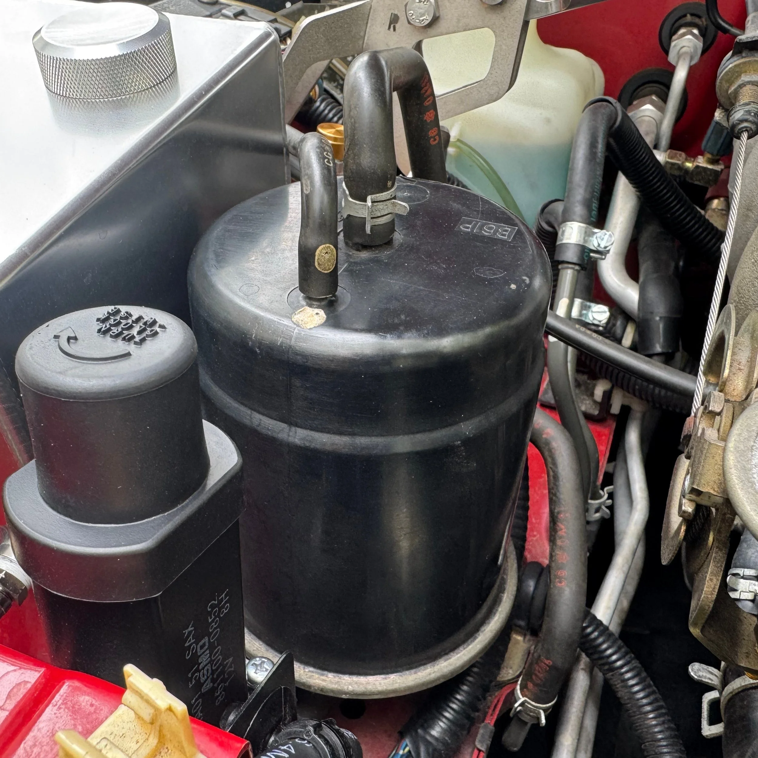 NA Mazda Miata MX-5 power steering fluid reservoir and headlight motor