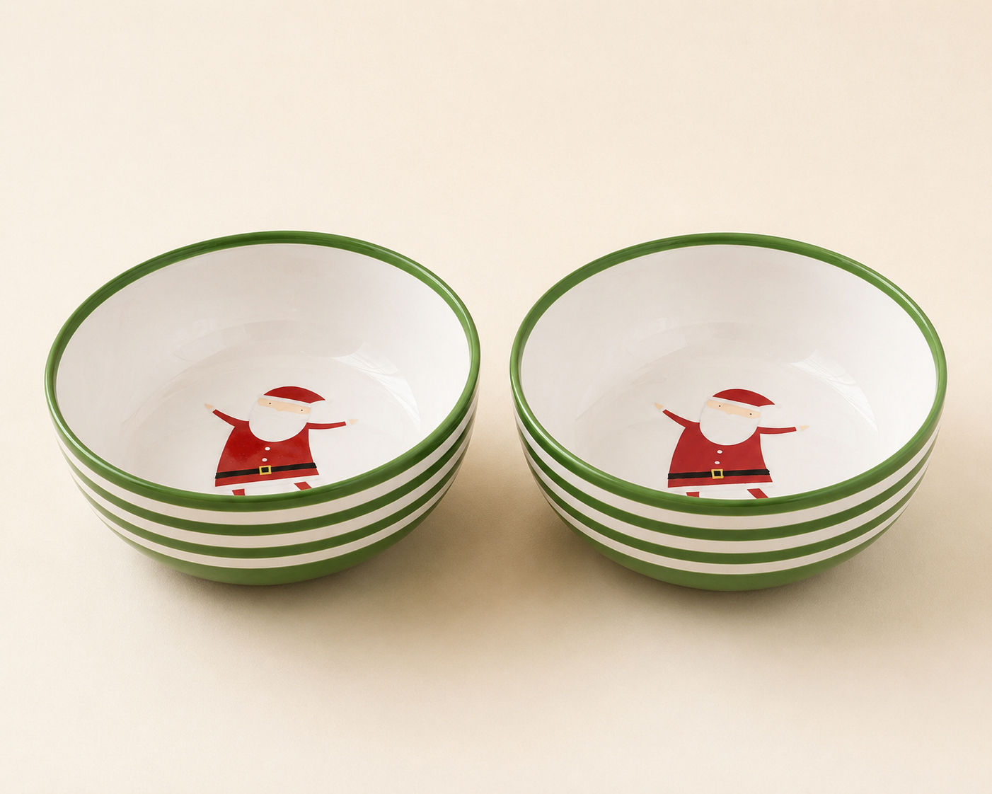 Two ceramic bowls with green and white striped exterior and interior featuring a Santa Claus illustration.