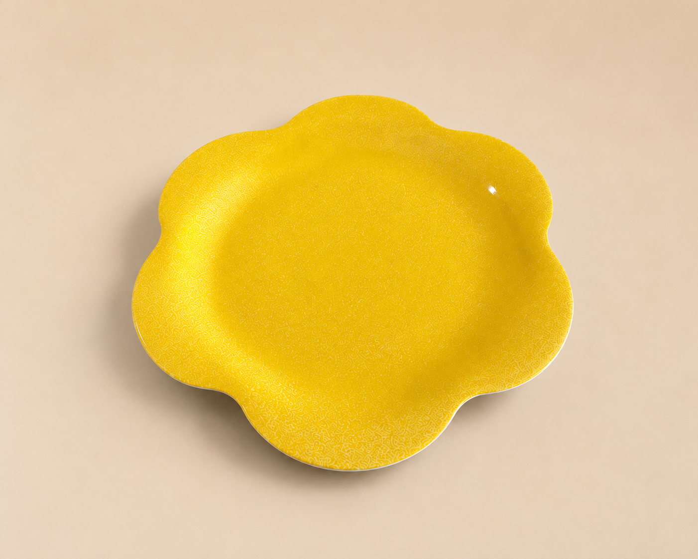 Yellow flower-shaped plate with a subtle pattern on a beige background.