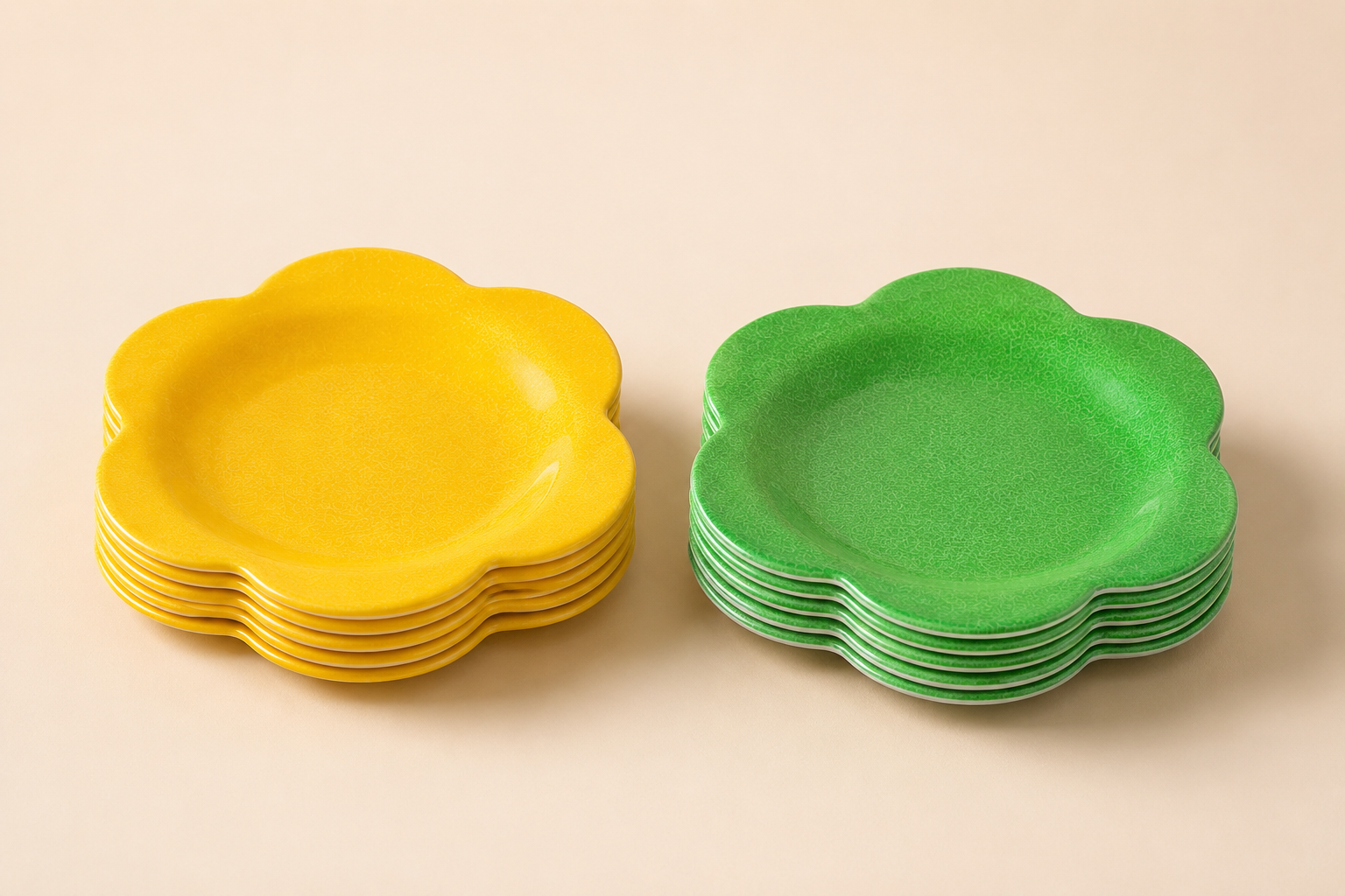 Stacked yellow and green flower-shaped plastic bowls on a white surface.