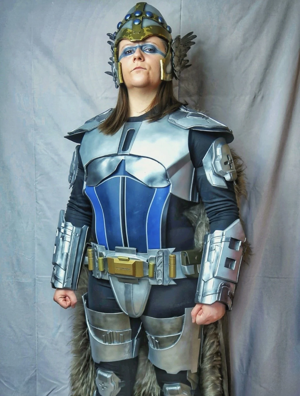 Woman dressed as Volcano Man from the Eurovision Song Contest movie, wearing armor, helmet, and faux fur accents.