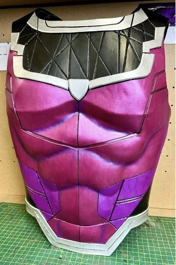 A detailed painting of Gambit's armor chest piece, predominantly metallic purple with gold accents, displayed vertically.
