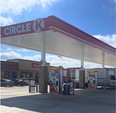 Circle K gas station with fuel pumps and convenience store under a red and white canopy.