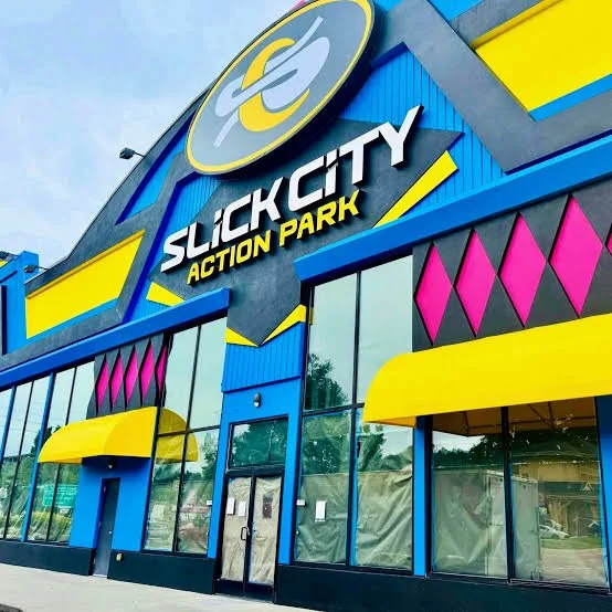 Exterior of Sucky City Action Park building with colorful blue, yellow, pink, and gray design elements.