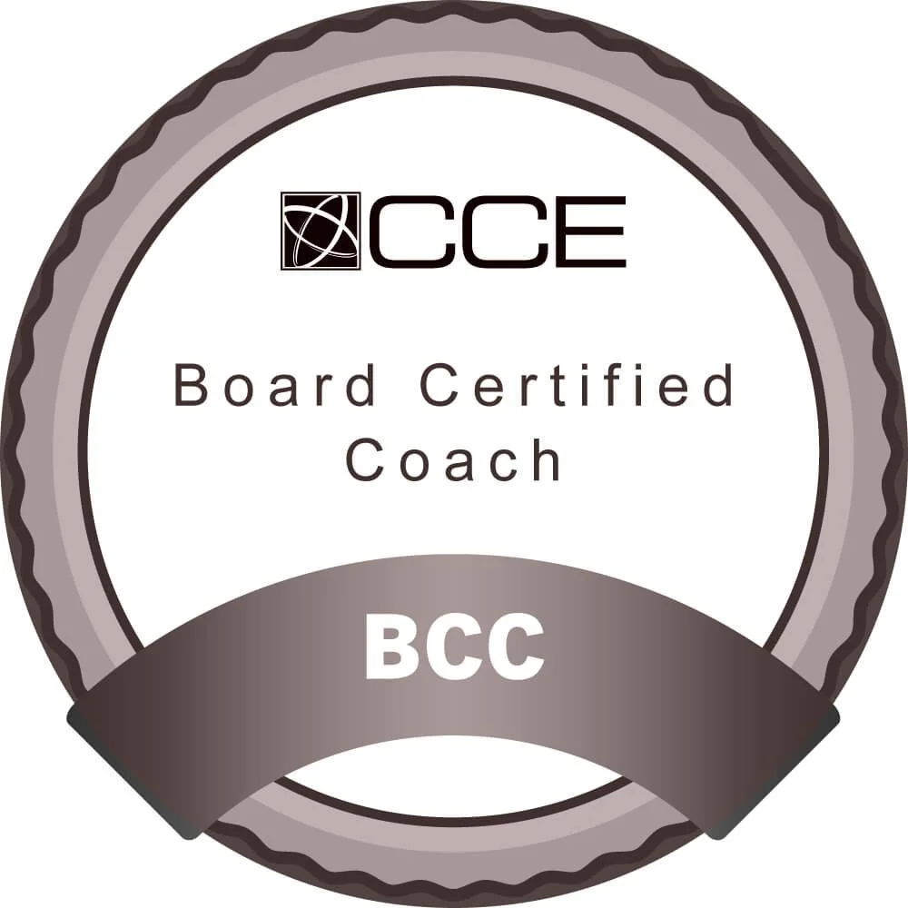 A certification badge that reads "CCE Board Certified Coach BCC" with a circular design and a black and white color scheme.