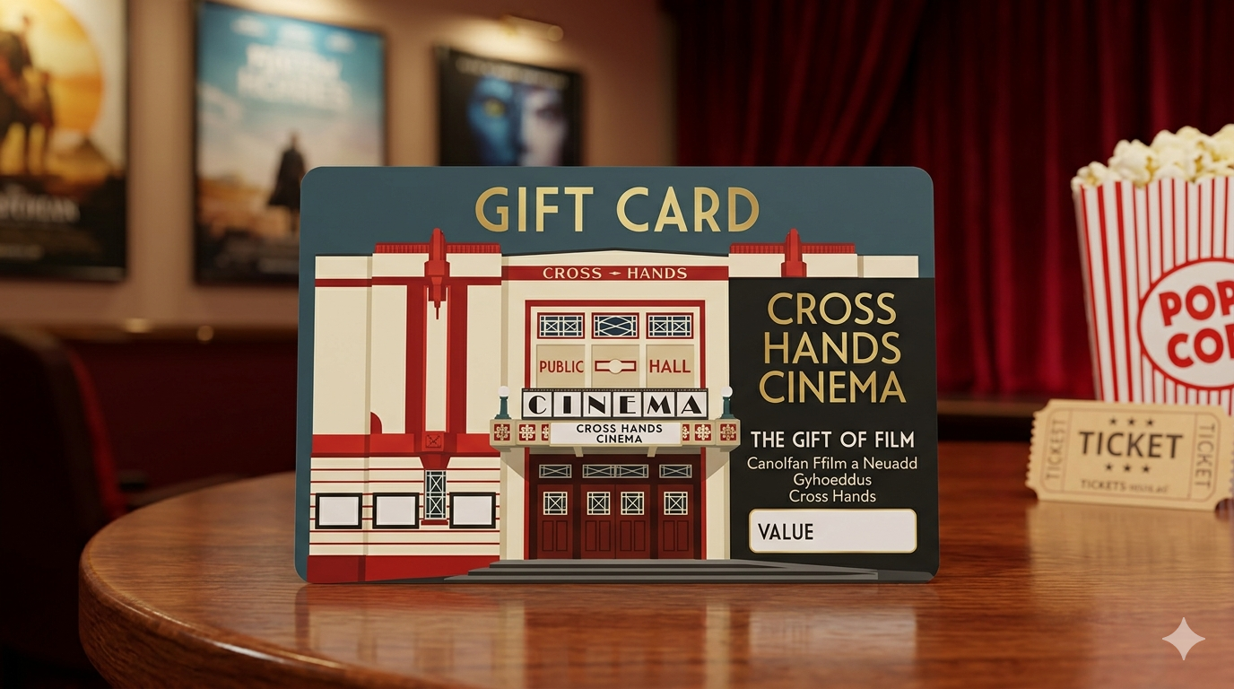 Gift card for Cross Hands Cinema featuring an illustration of a historic theater building with red and white accents, on a wooden table with popcorn and tickets in the background.