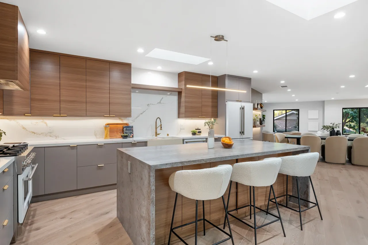 Modern kitchen island with horizontal wood‑grain cabinetry and gray accents in a Los Angeles home.