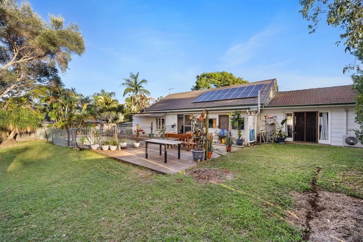 Rear patio and garden at 18 Daveson Road, Capalaba, with solar panels visible on the roof.