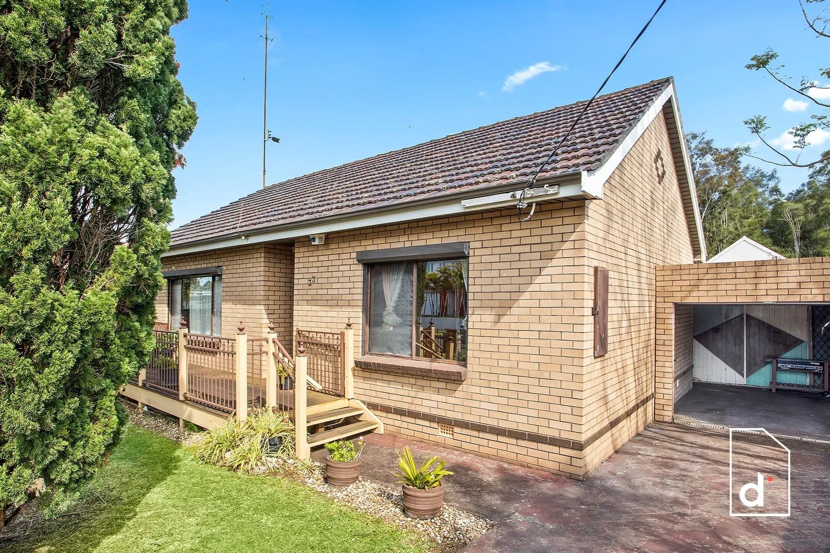 Front exterior of the original brick house at 33 Edgar Street, Towradgi with tiled roof, porch and side driveway.
