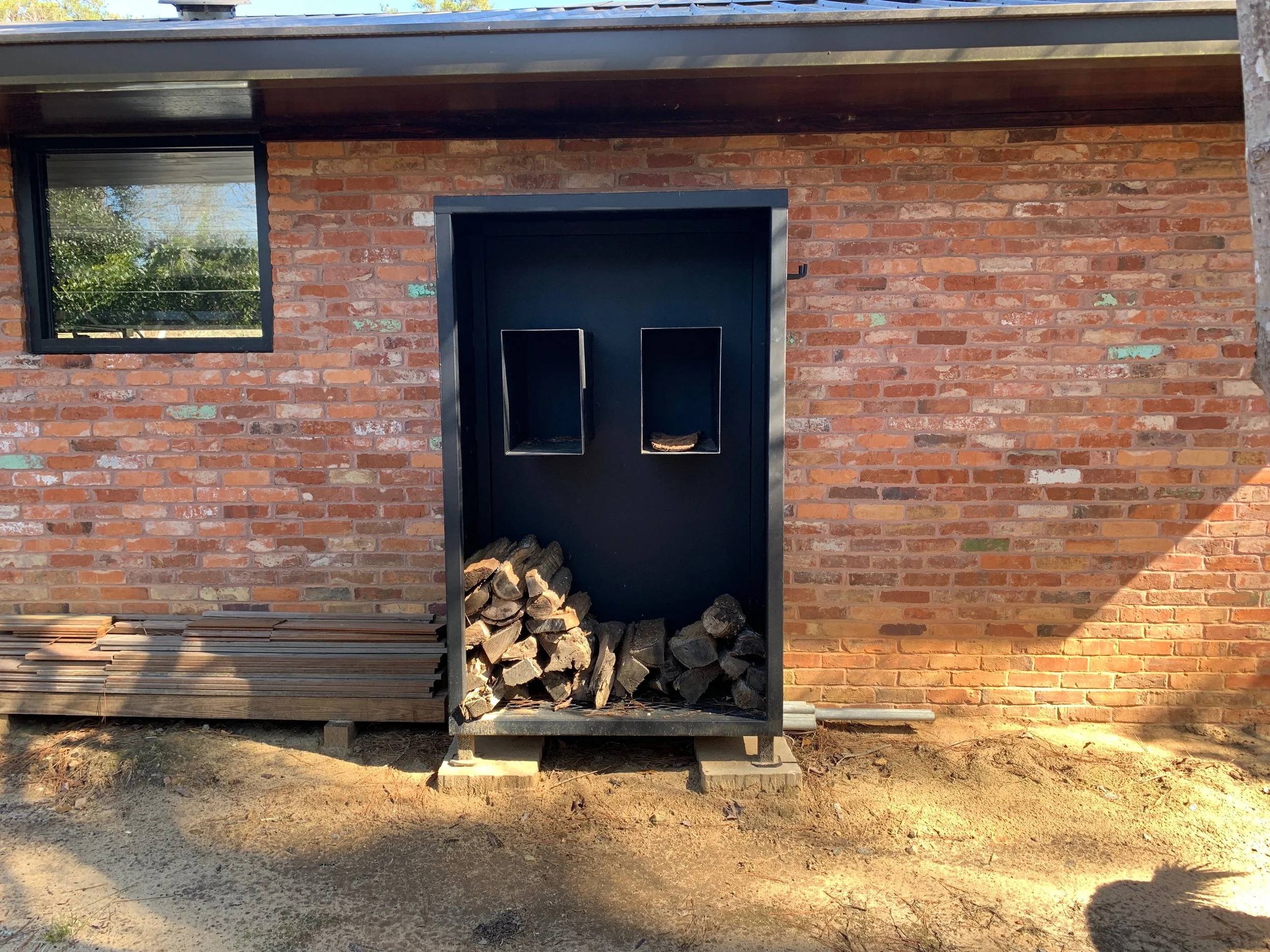 Firewood rack with integrated glove/tool shelves