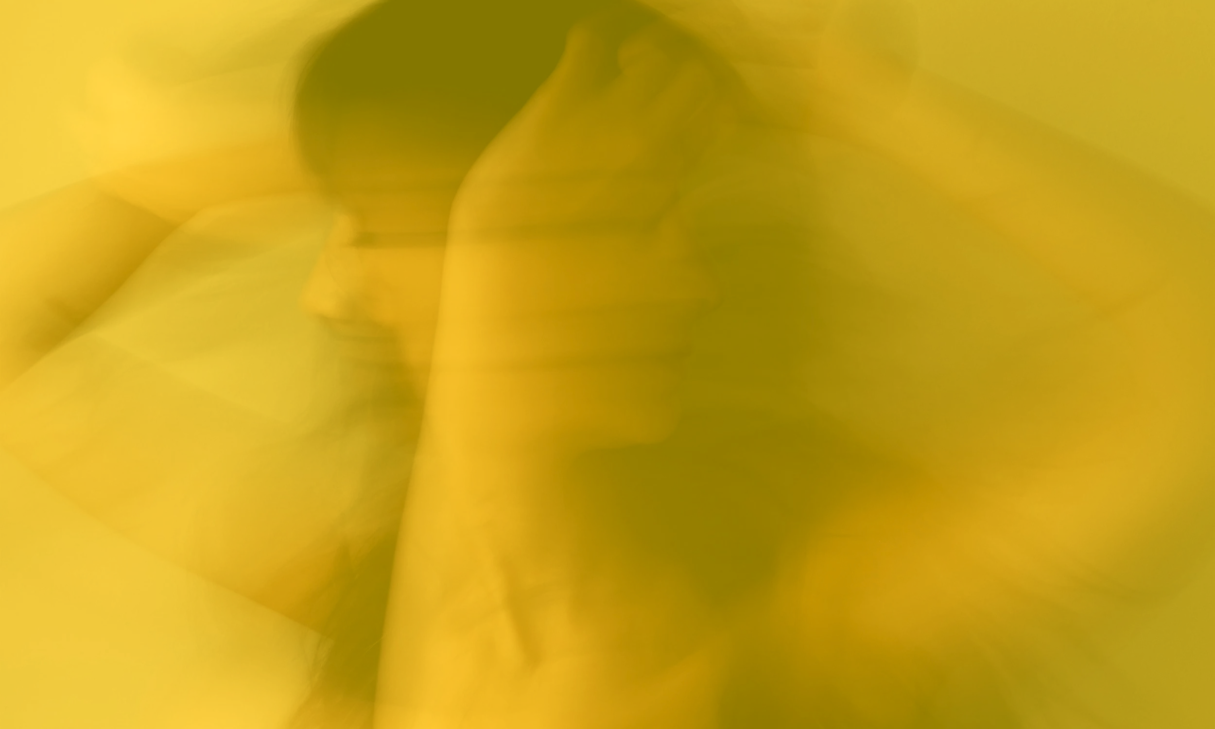 soft blurred portrait in warm yellow tones expressing overwhelm and emotional intensity
