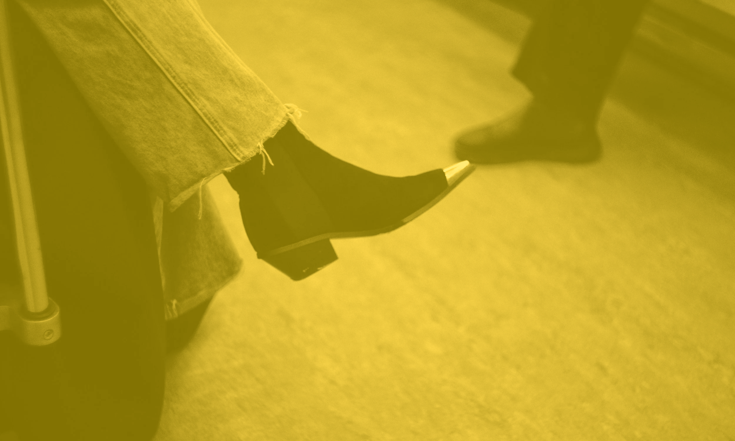 An empowered woman wearing black shoes and jeans