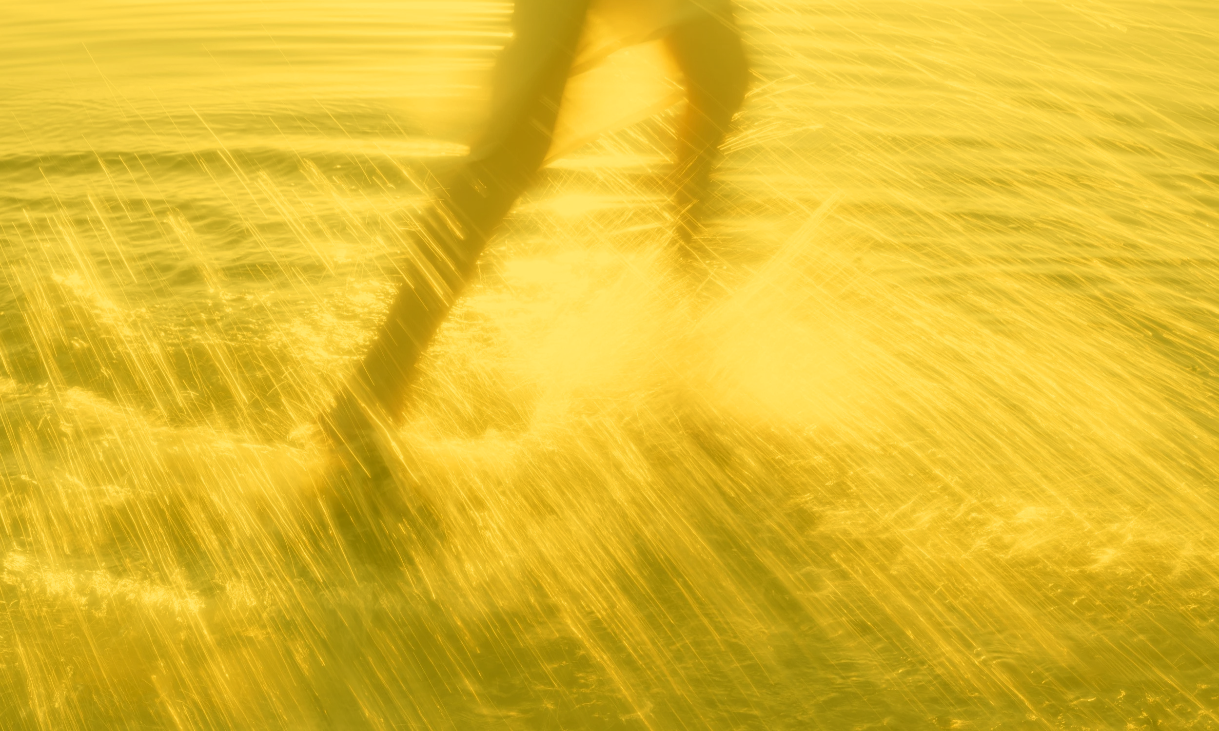 blurred motion of running through golden field representing movement, healing, and forward momentum in healing journey
