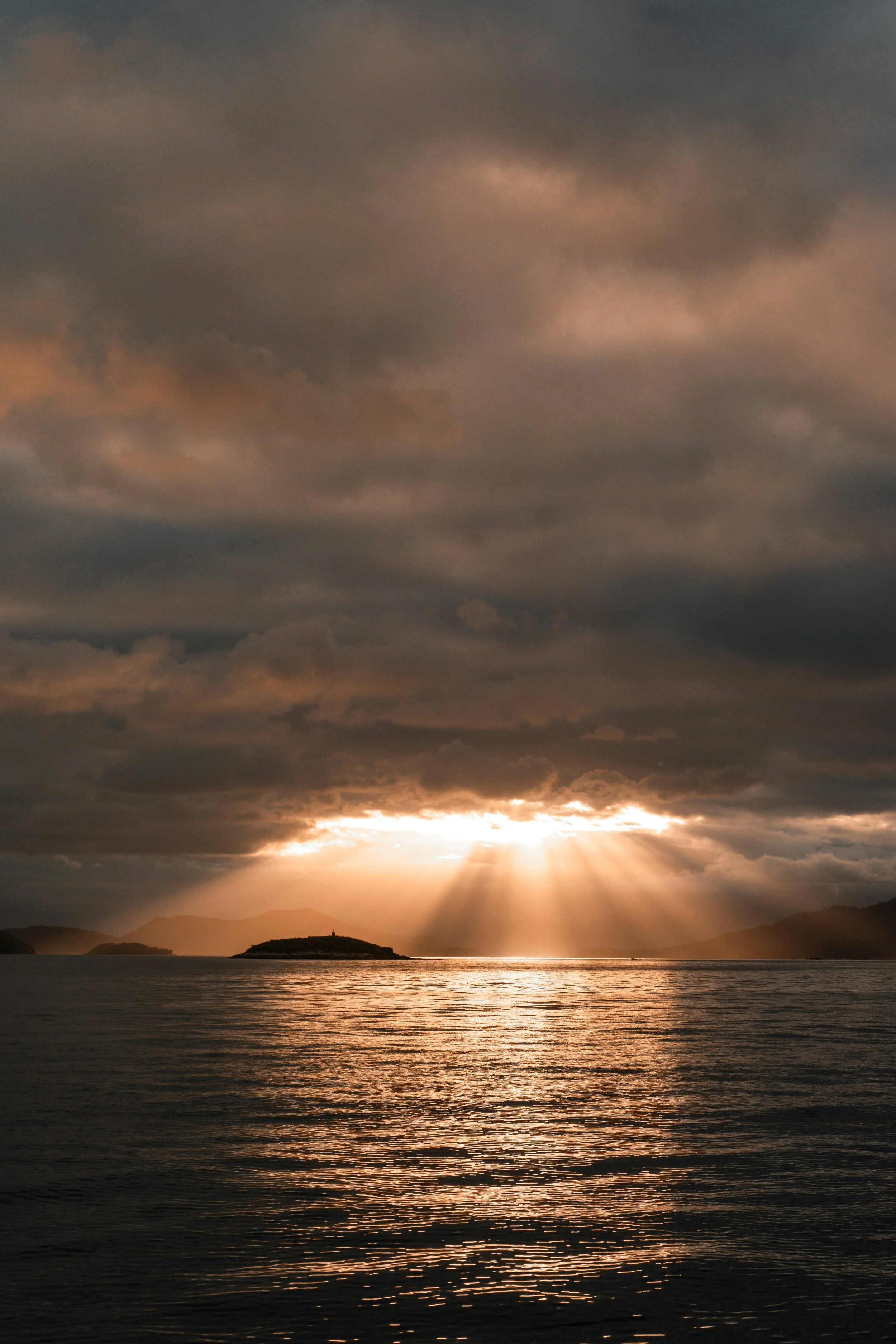 sunlight breaking through clouds over ocean representing hope, clarity, and healing for women going through difficult times