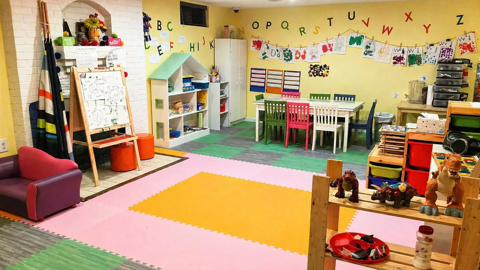 Colorful children's classroom with tables, chairs, toys, art supplies, and educational decorations on yellow and white walls.