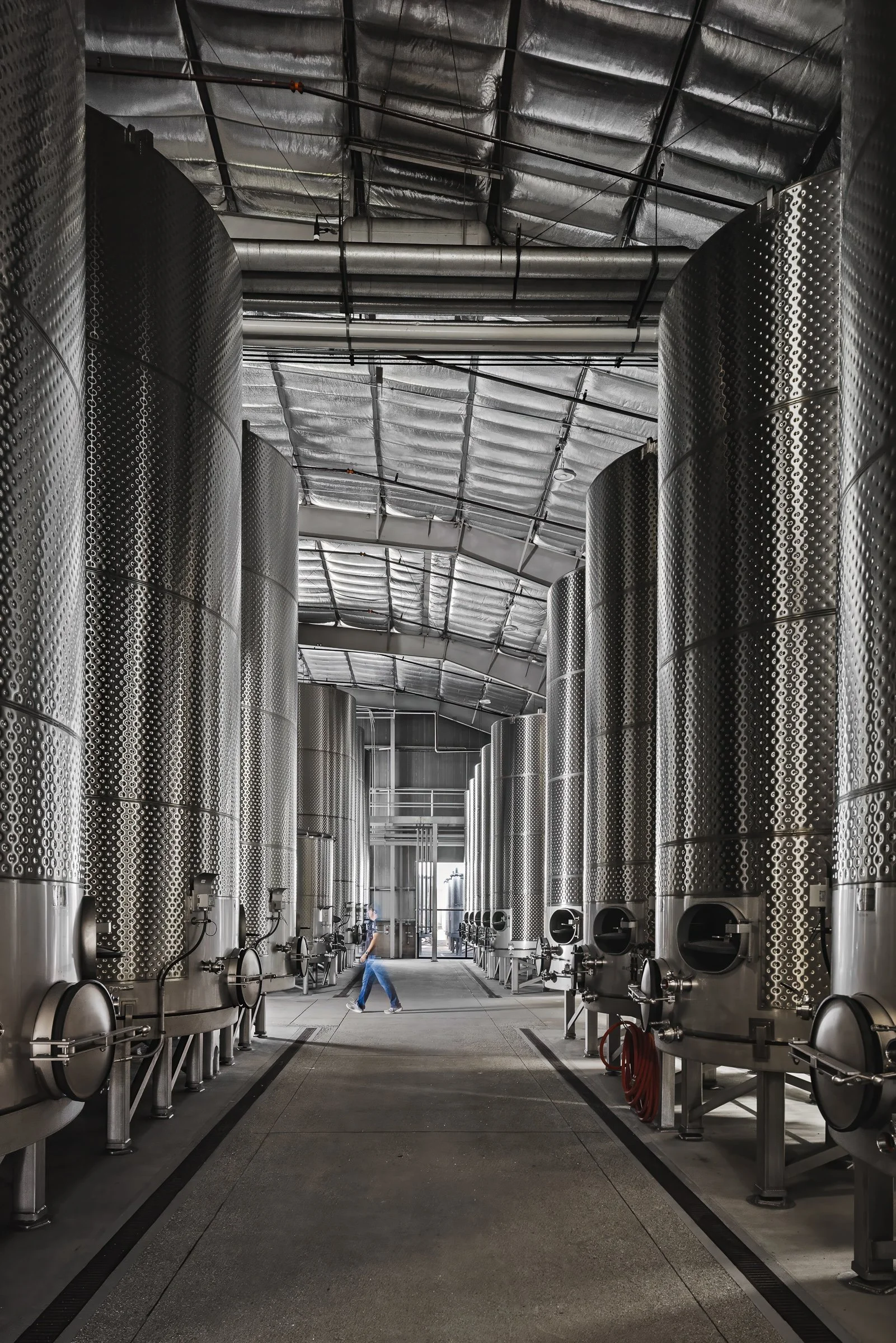 Stainless steel wine fermentation and storage tanks at custom crush facility in San Luis Obispo.