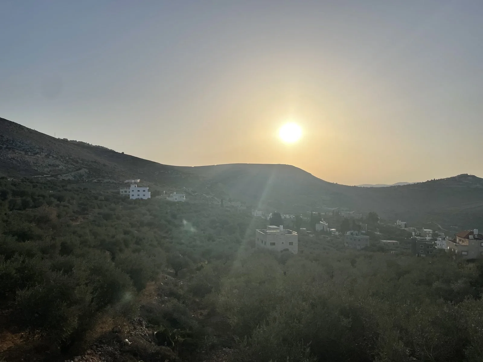 Burin-sun-rising-behind-hilltop-settlements.jpg