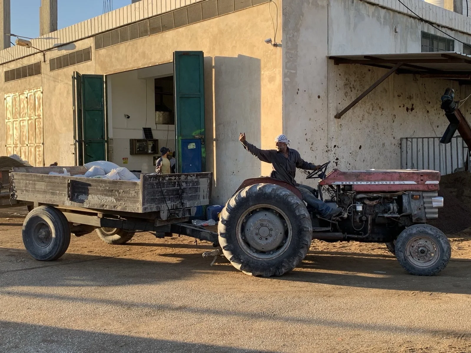 A-farmer-dropping-his-harvested-olives-off-at-the-olive-press-in-Burin.jpeg