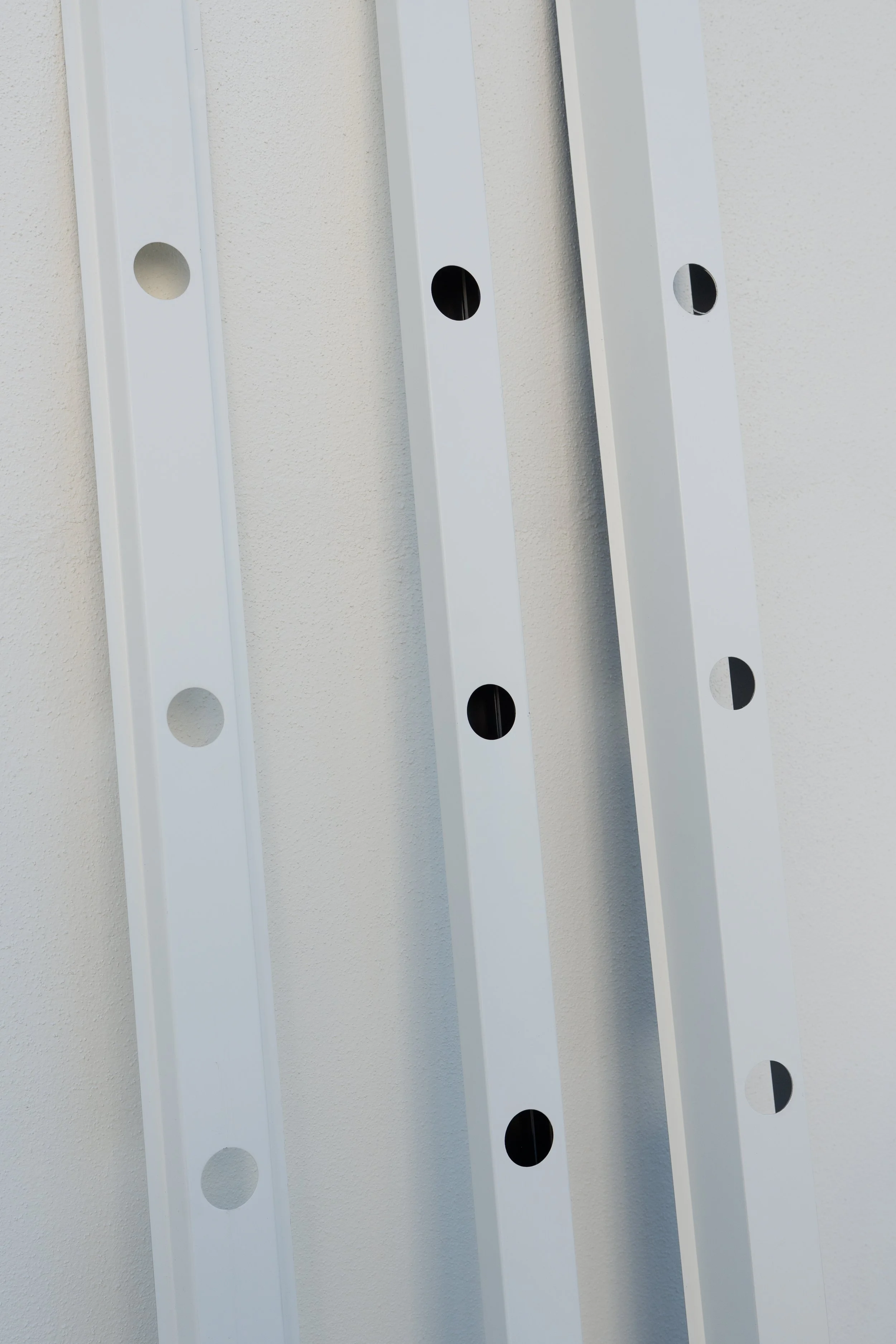 Close up of 3 aluminum hat tracks used for LED lighting.
