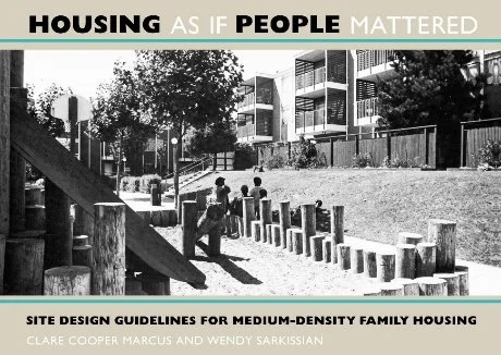 A group of children playing on a playground near a modern apartment complex with trees and a fence, promoting housing as if people mattered.