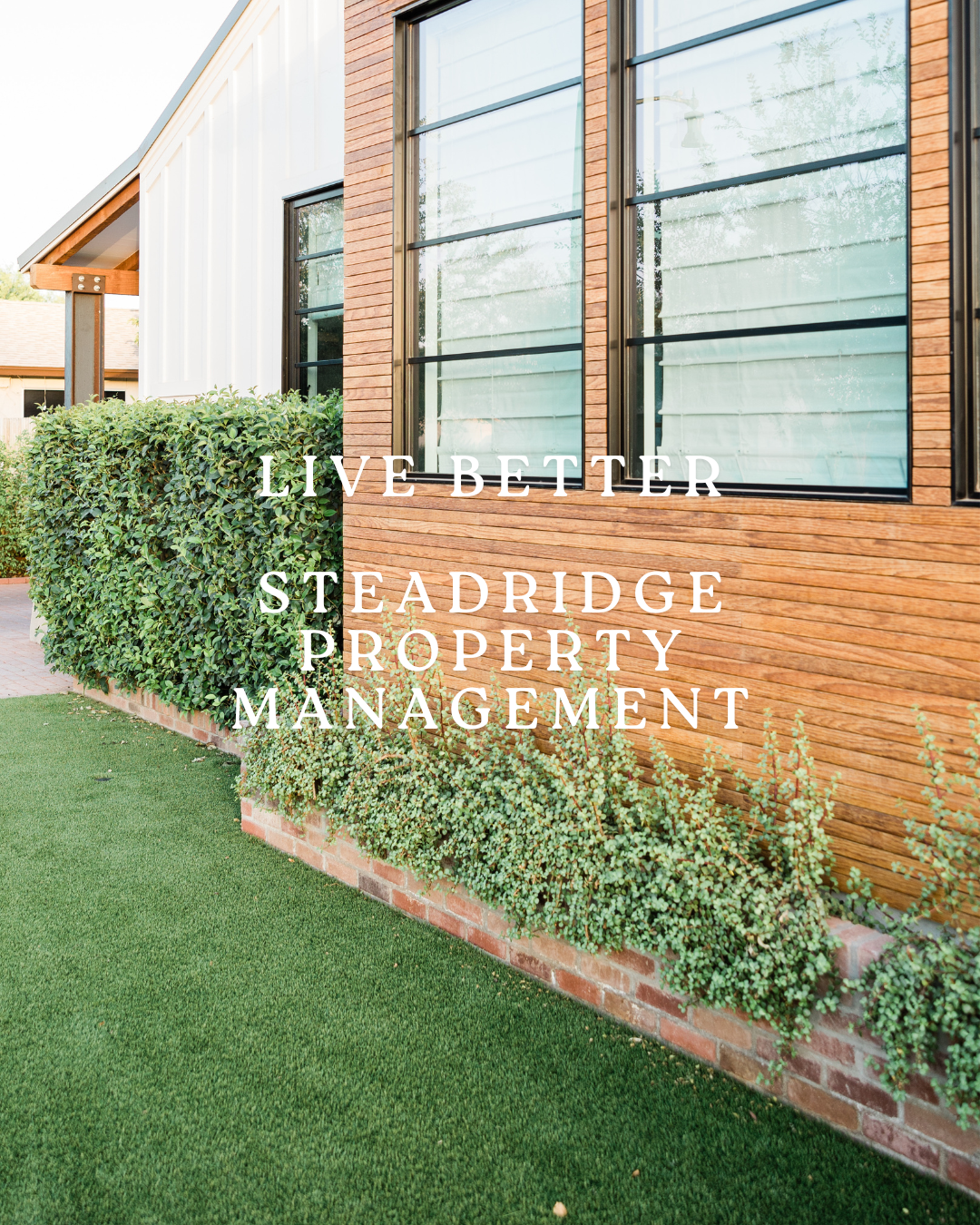 Exterior view of a modern house with large windows, green bushes, and a well-maintained lawn, with overlay text that reads "Live Better Steadwise Property Management."