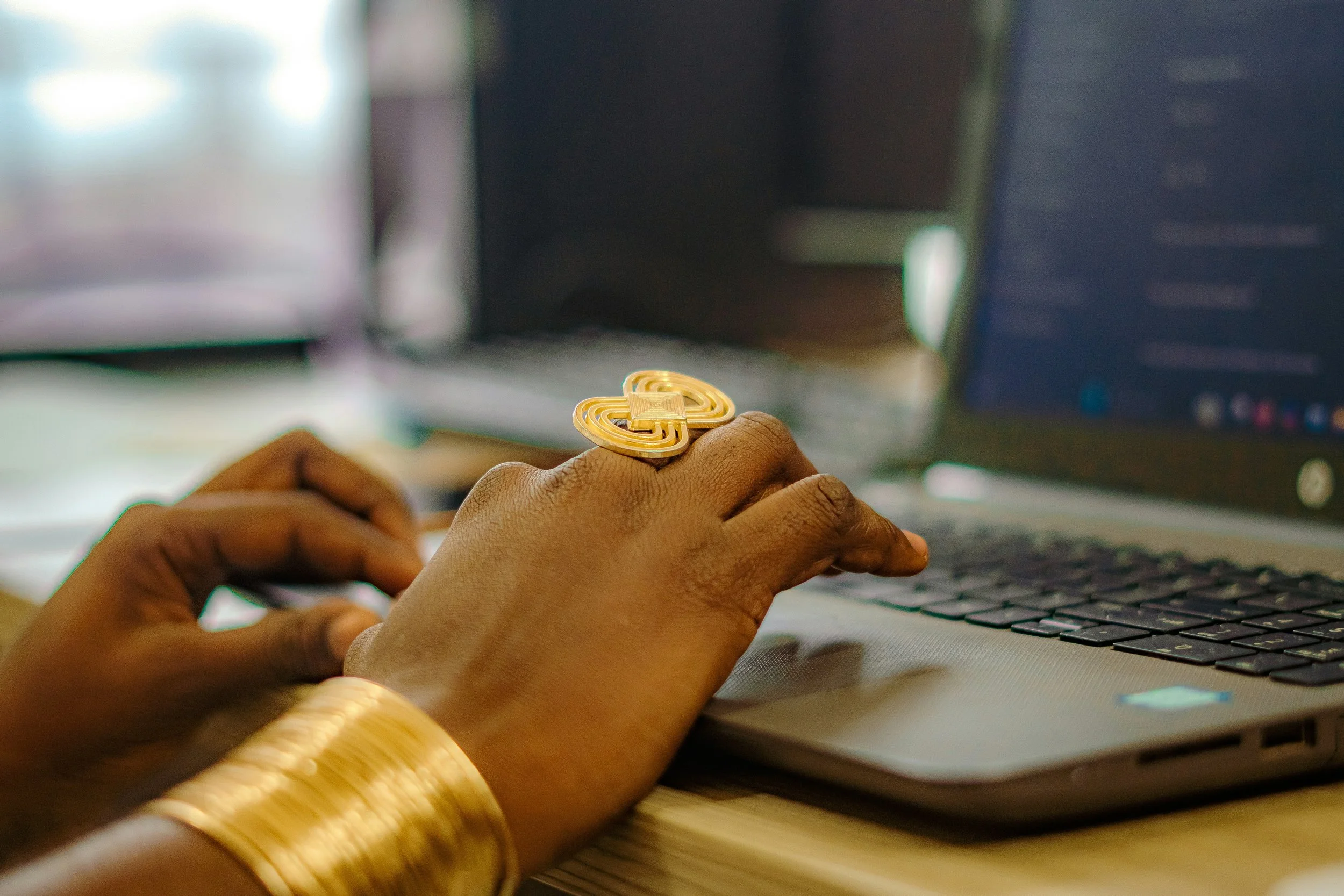 a hand typing on a computer