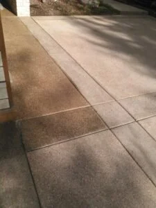 Freshly sealed concrete section with different colored sections.