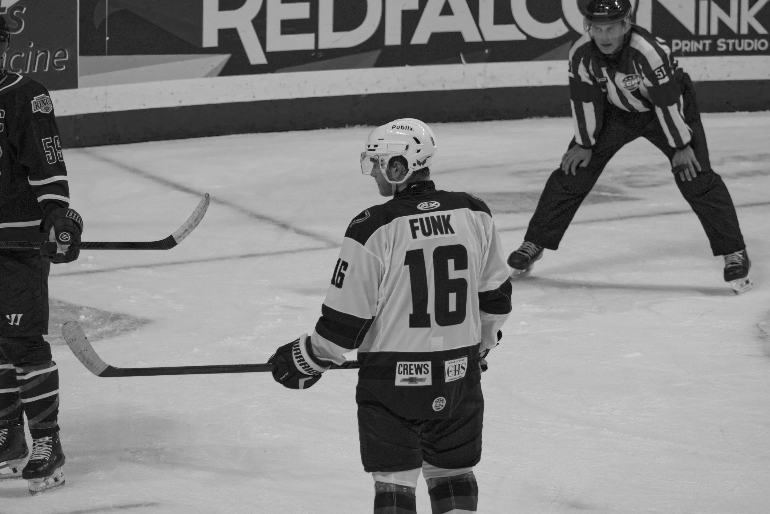 Hockey players and referee on ice rink during a game