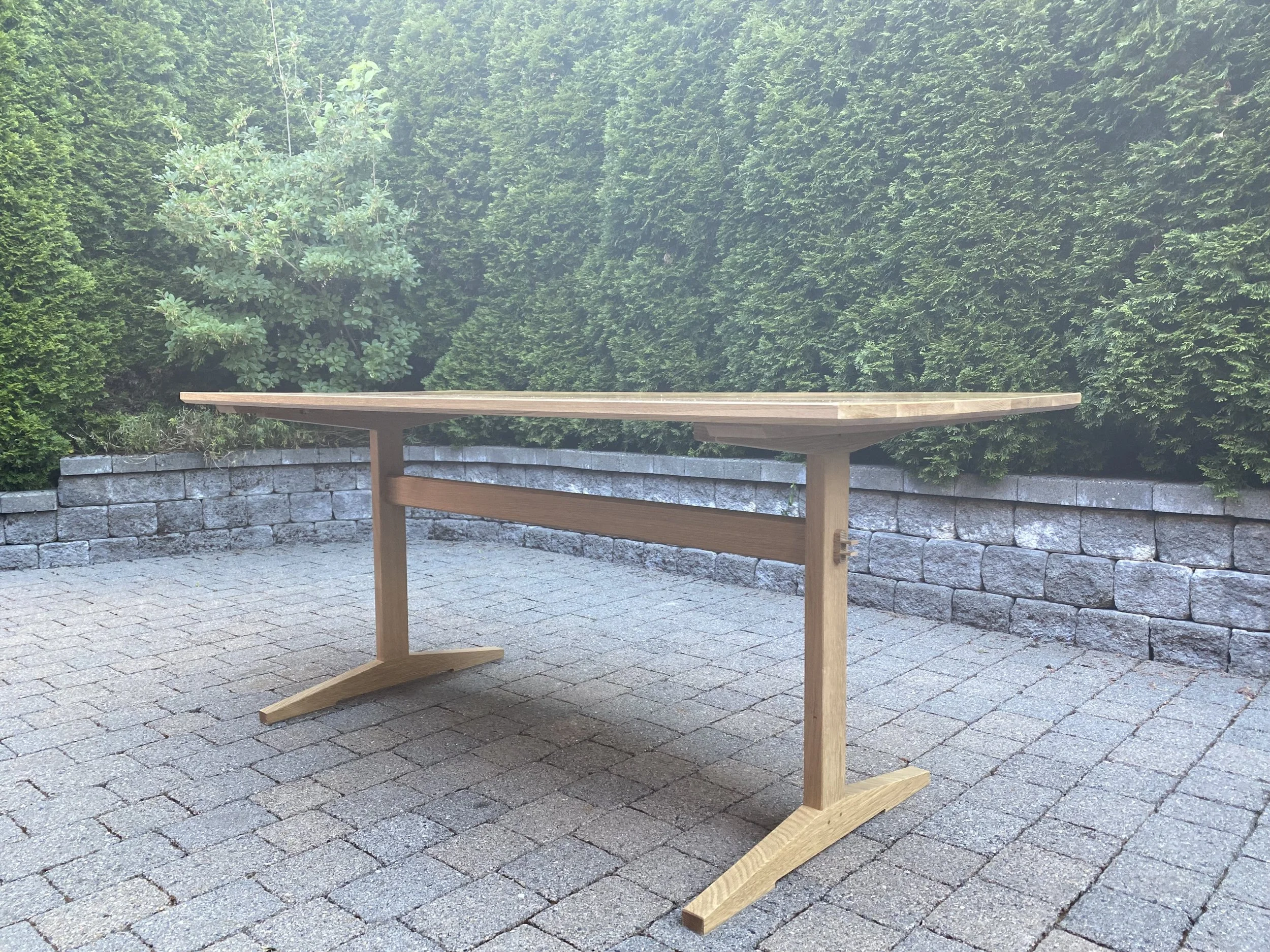 WHITE OAK TRESTLE TABLE, side angle view | flat sawn oak top, quarter sawn oak base | 72"W x 32"D x 30.25"H