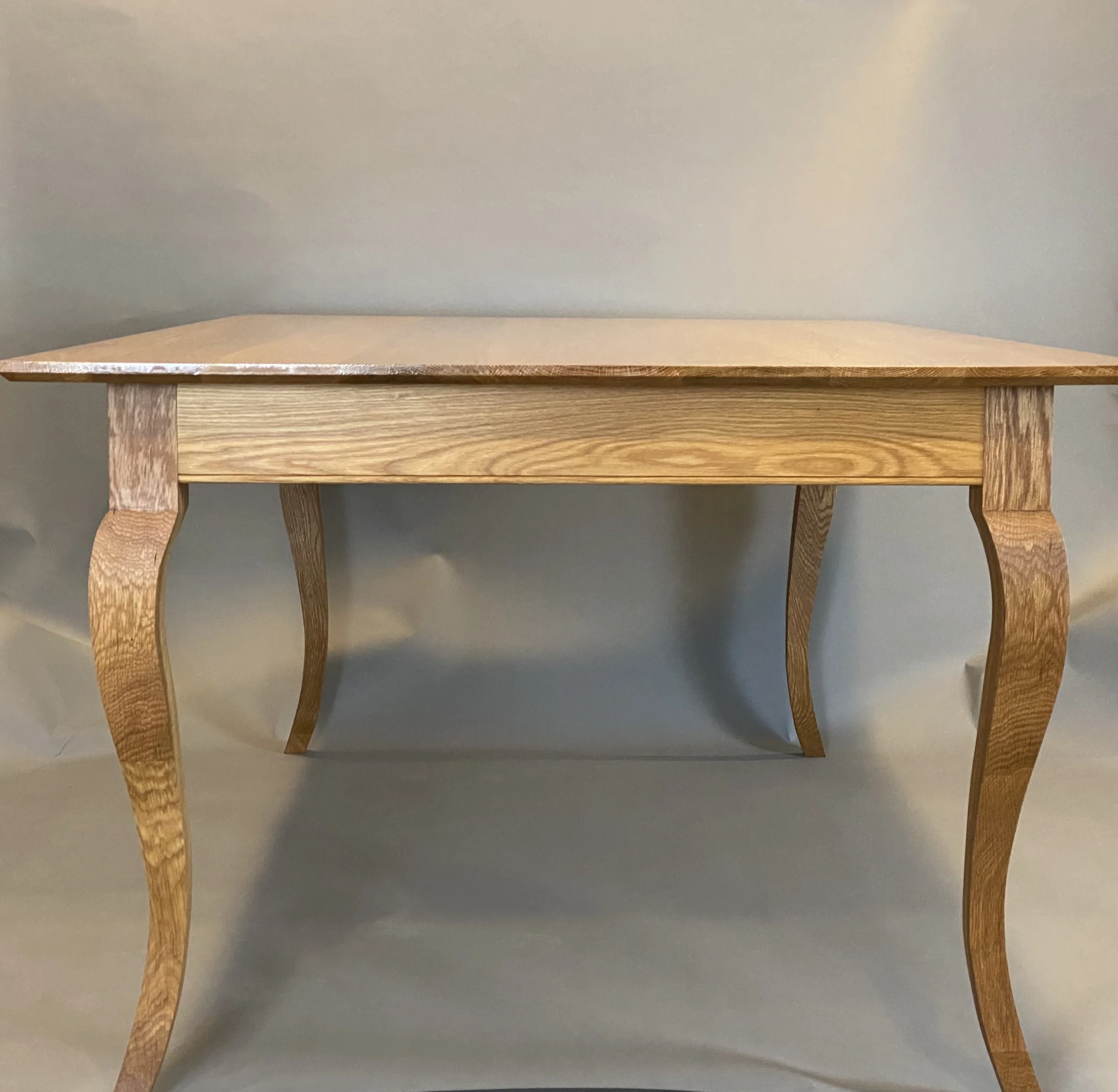 SEGAL-WINTERLING DINING TABLE, side view | french country style, white oak with hand sculpted cabriolet legs, finished with gloss varnish | 72"L x 43"W x 30"H
