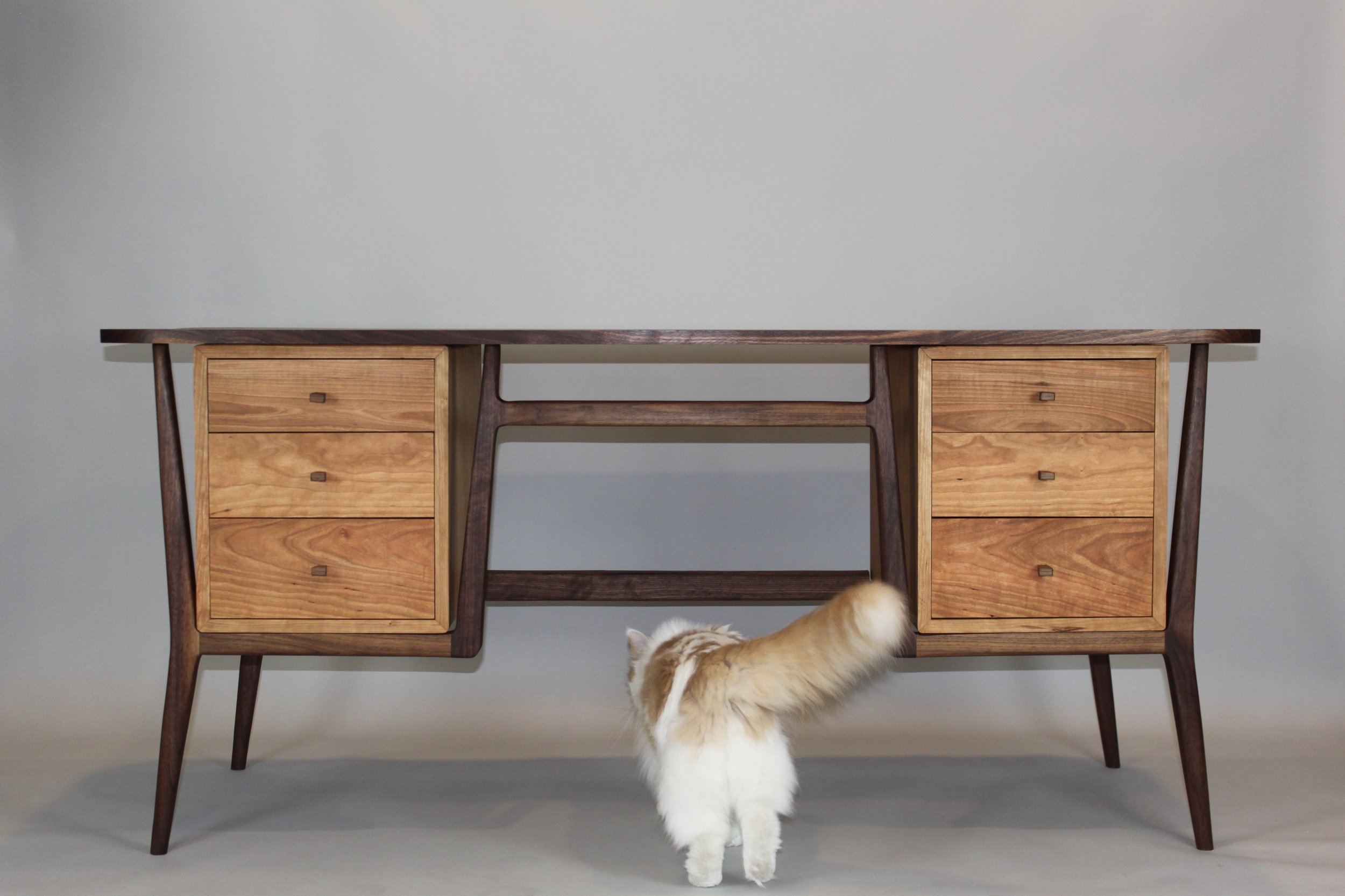 MID-CENTURY MODERN DESK, front view with cat |  walnut frame & top, cherry cases & drawers | 64"W x 30"D x 29.5" H