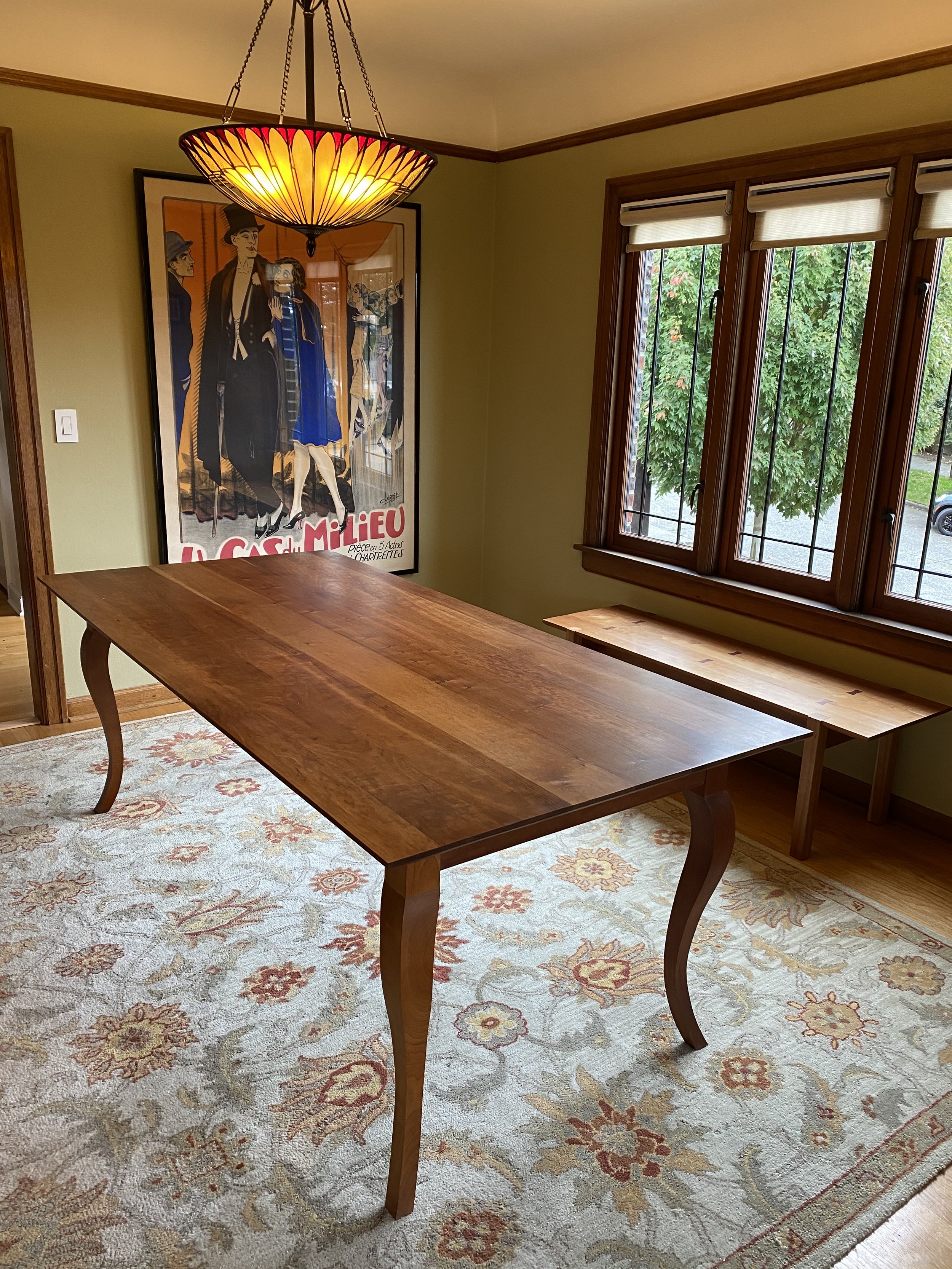 ANNE'S DINING ROOM TABLE, side angle view | cherry |  features cabriolet legs | surfaces finished in a varnish oil | 80”L x 38.25”W x 30”H