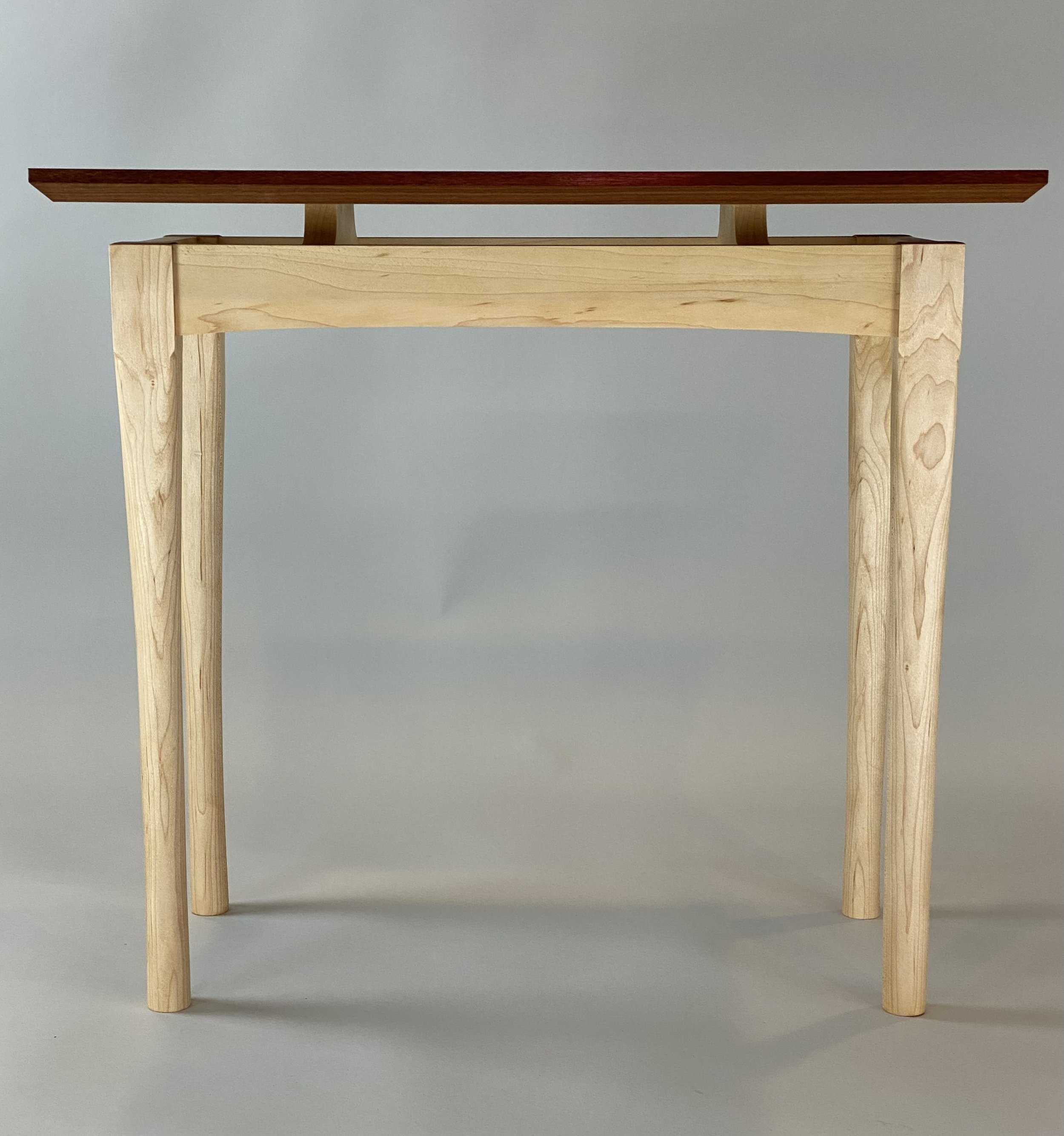 MAPLE SIDE TABLE, front view | part of set of two maple/makore side tables | legs shaped by hand with a spoke shave & then sanded, base designed to "float" the top | individual table dimensions are 13"W x 24"D x 21.75" H