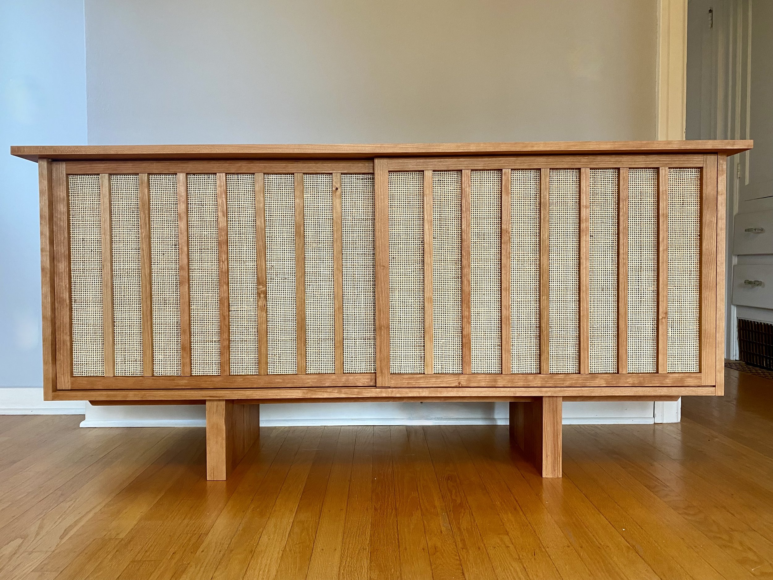 Double sliding door cherry cabinet I Rattan backing on the doors
Dimensions - 65"W x 18"D x 31"H