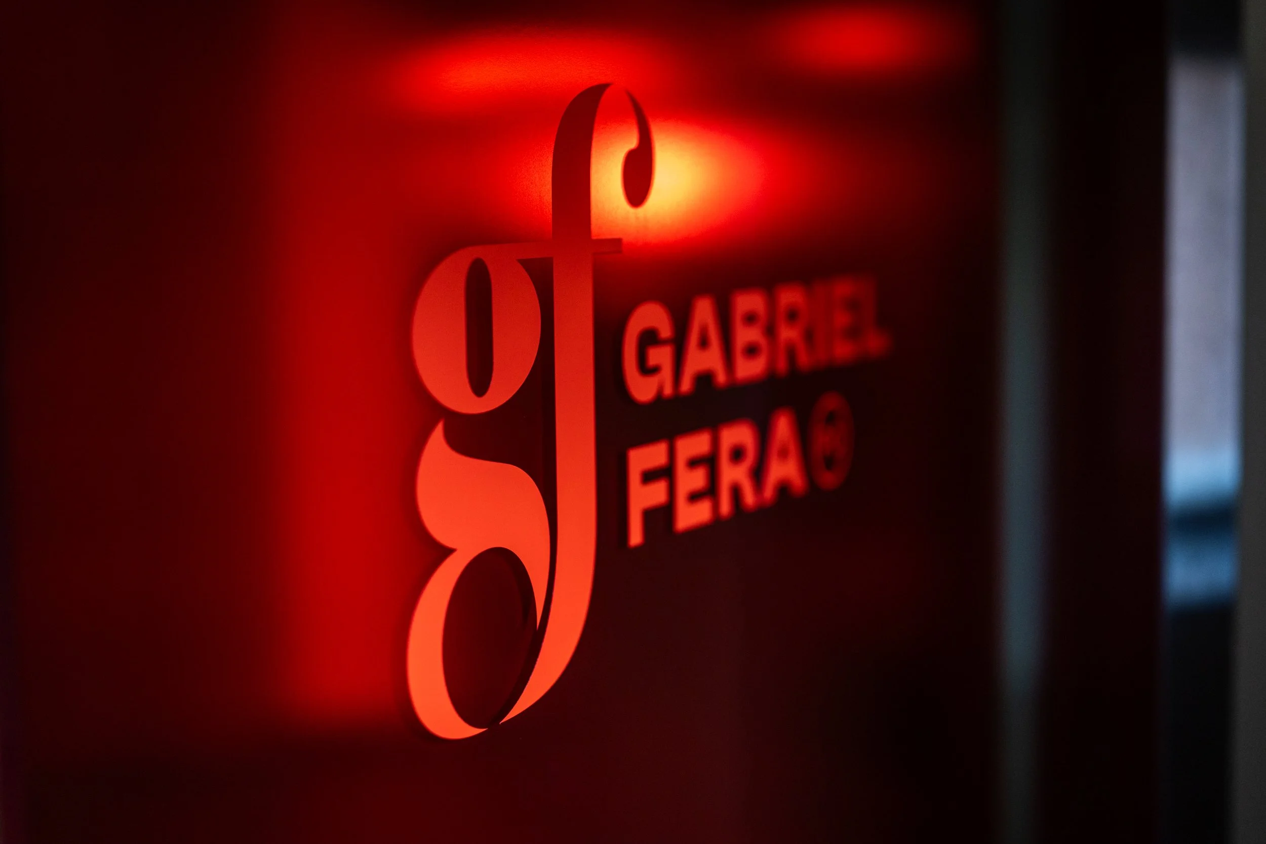 Red illuminated sign with the text 'Garage' and 'Ferro' visible, and a stylized arrow or shape above the text.