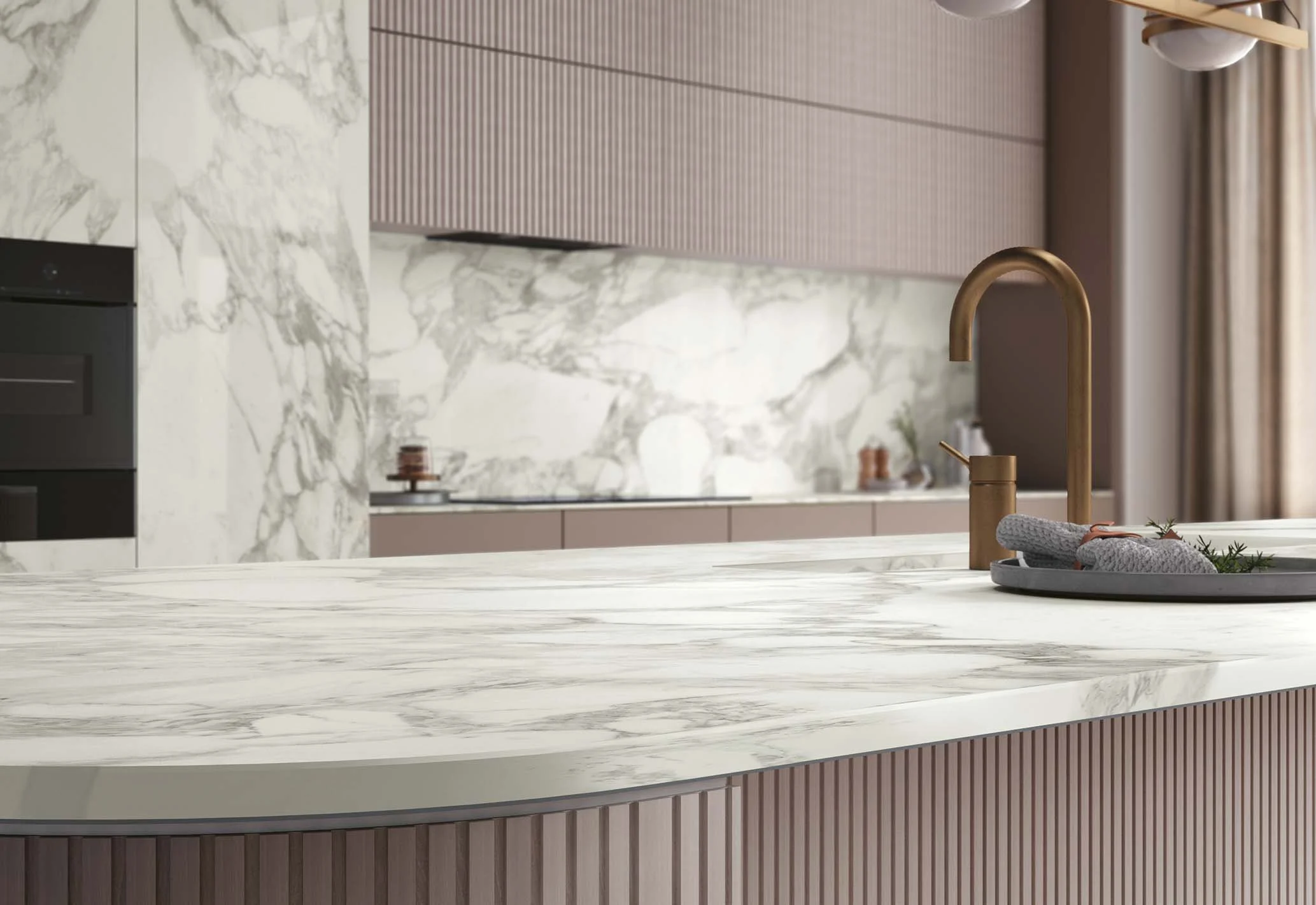 Contemporary kitchen with marble-look porcelain countertops and a veined backsplash.