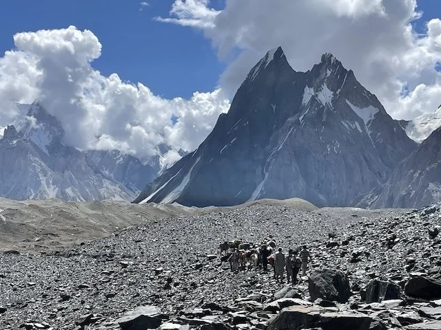 trekking on the Baltoro glacier with Mitre Peak in background