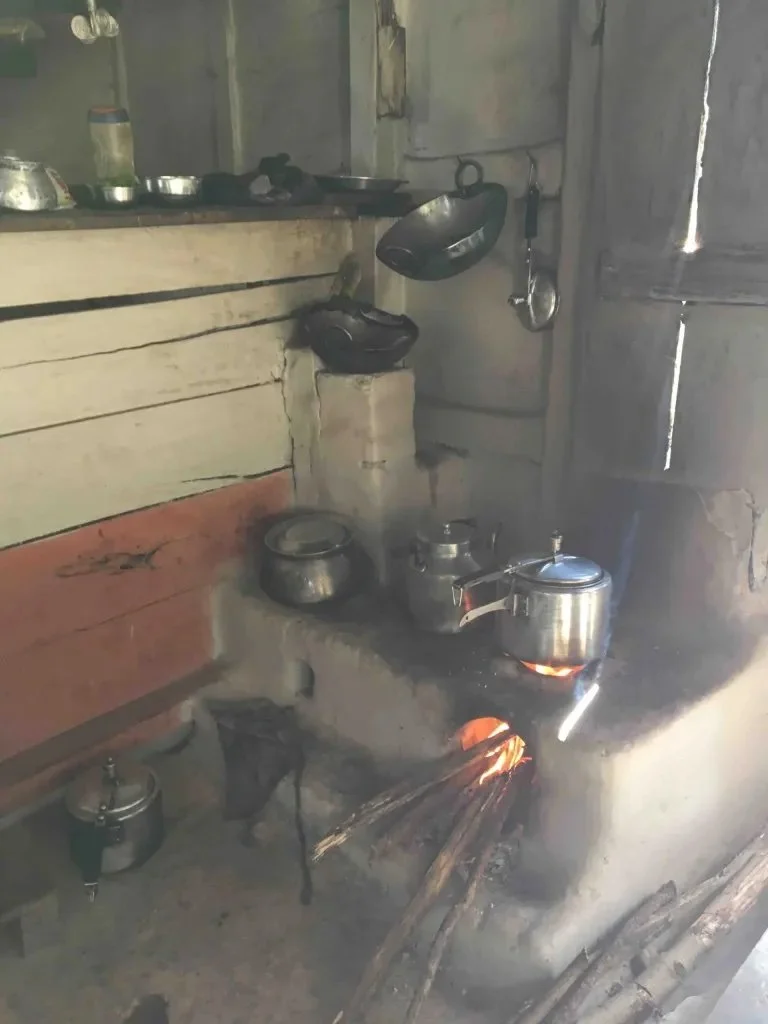 inside a teahouse showing pots and pans cooking over a fire