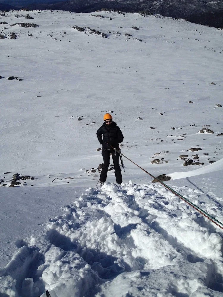 look down from teh top of the snow slope to an abseiler