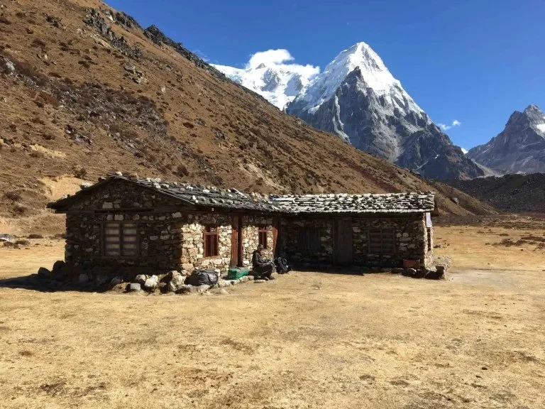 The rustic teahouse at Ramche with mountains behind