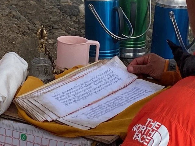 a book of Tibetan prayers at the puja
