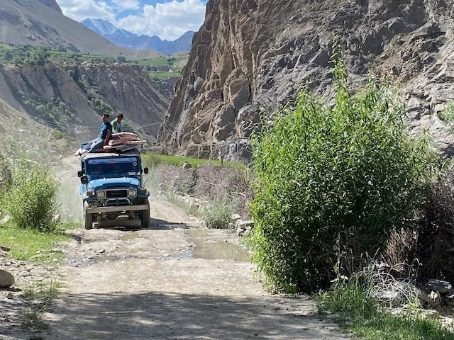 Riding atop jeep en route