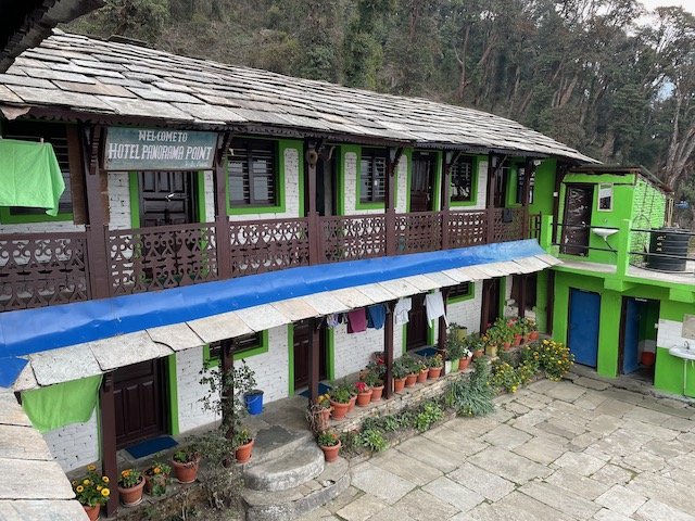 a well kept teahouse with potplants outside