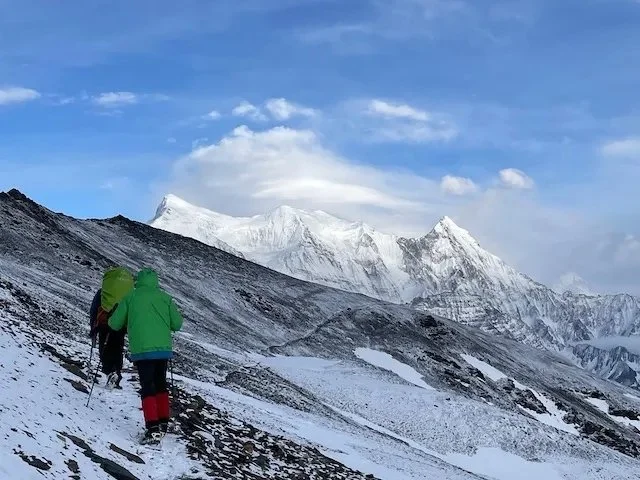 Trekking along Dhampus Pass with view to Nigiri range of mountains